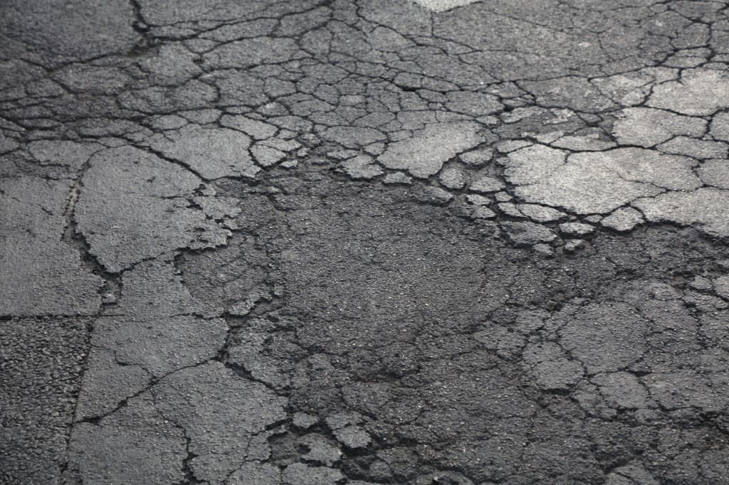 Cracked and failing asphalt pavement